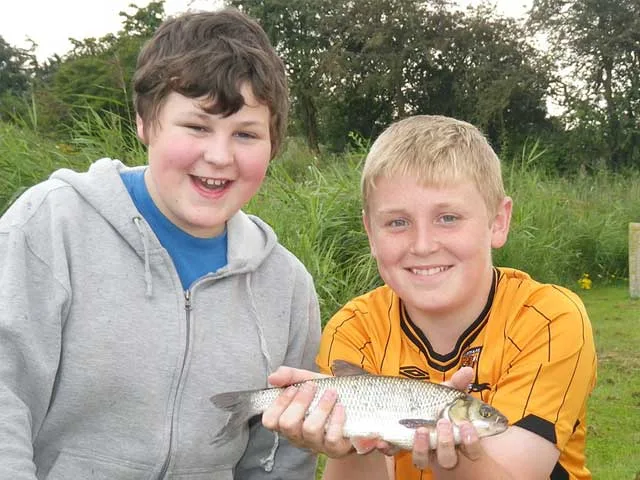 Junior anglers displaying their catch