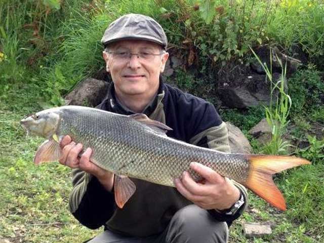 Tim Thompson with a good barbel from Carlton on Trent